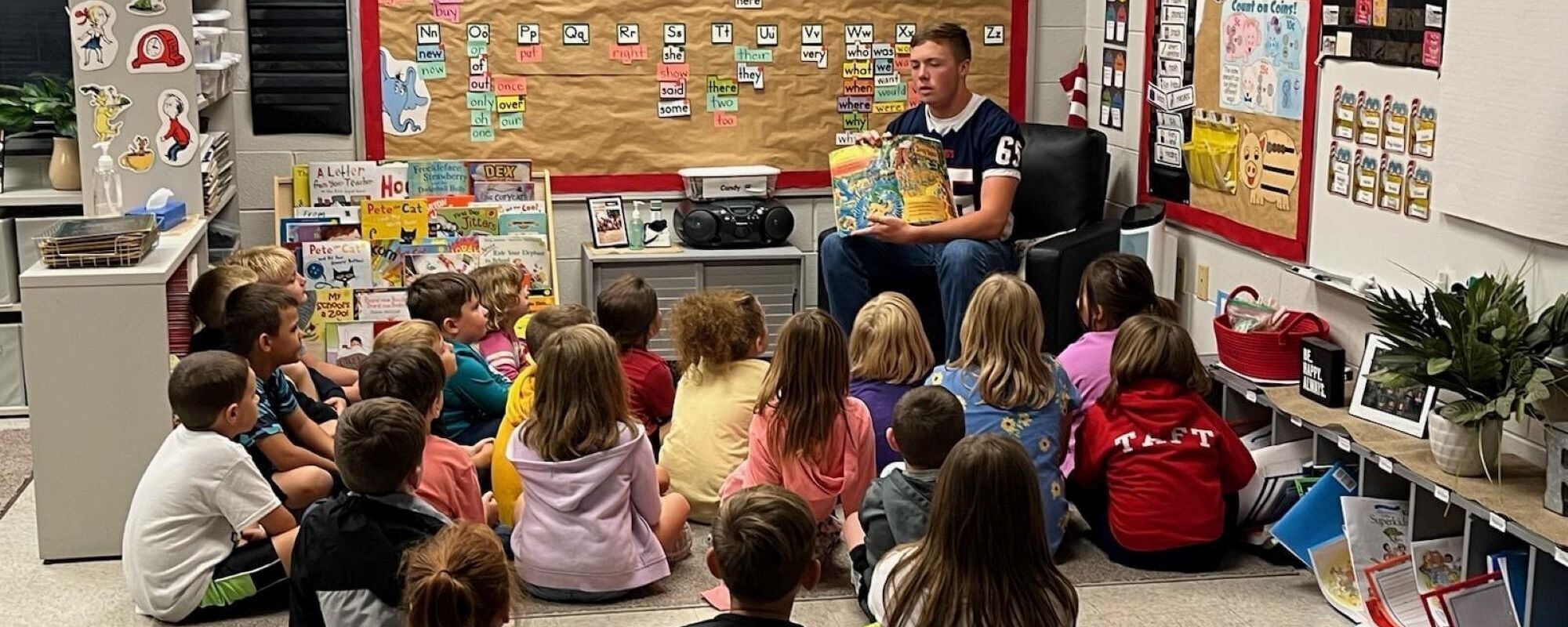 Our Football players reading to elementary class.